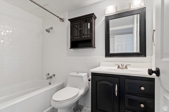 full bathroom featuring tile walls, toilet, vanity, shower / bath combination, and a wainscoted wall