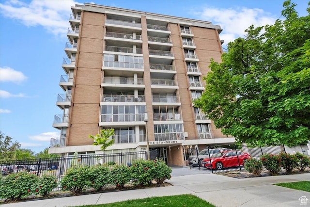 view of apartment building / complex with fence