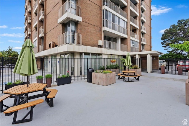 view of apartment building / complex featuring fence