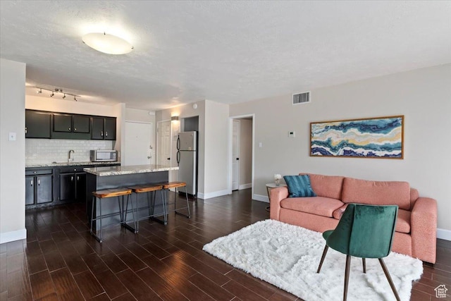 living room featuring baseboards and dark wood finished floors