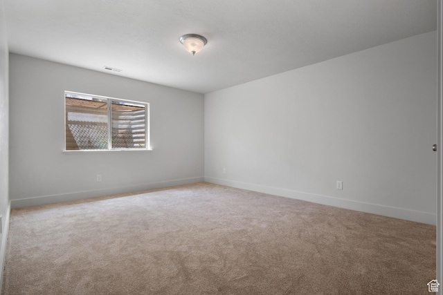 spare room with carpet floors and baseboards