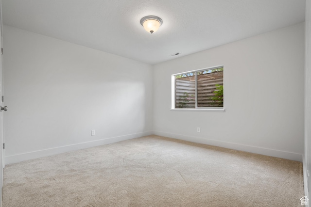 empty room with carpet floors and baseboards