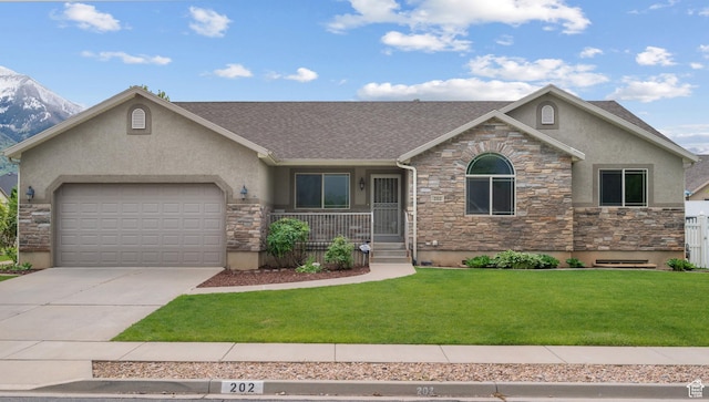 view of front of house featuring stone siding, stucco siding, a garage, and a front lawn