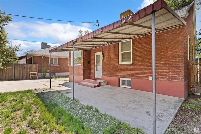 3214 Porter Ave, Ogden, UT 84403 - rear view of house featuring brick siding and fence