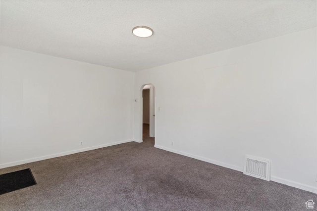 3214 Porter Ave, Ogden, UT 84403 - spare room featuring arched walkways, dark carpet, baseboards, and a textured ceiling