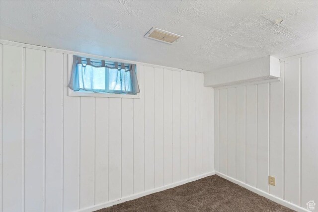 3214 Porter Ave, Ogden, UT 84403 - below grade area with a textured ceiling and dark carpet