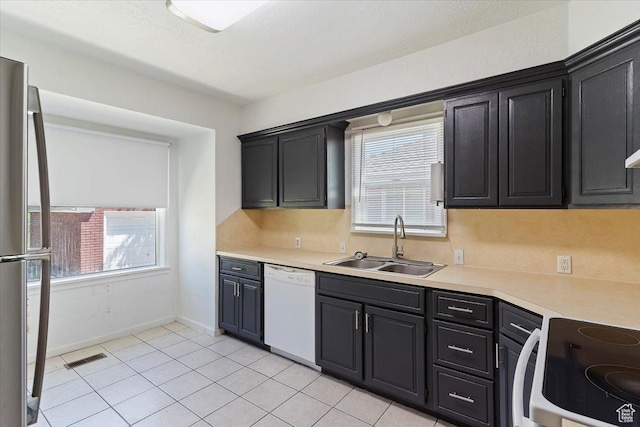 3214 Porter Ave, Ogden, UT 84403 - kitchen with a sink, dishwasher, stainless steel refrigerator, and plenty of natural light