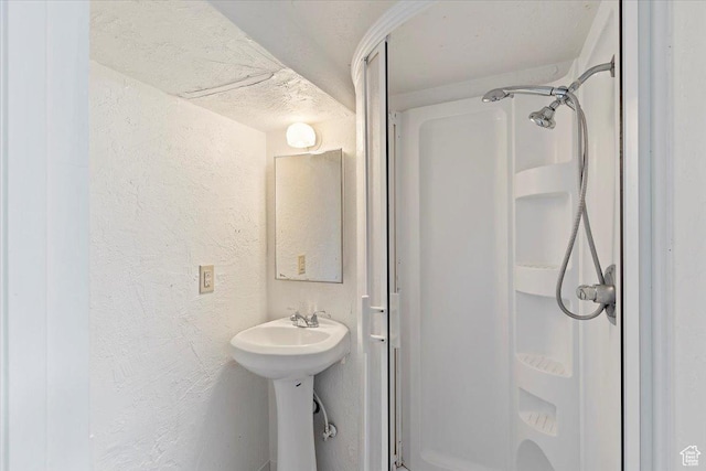 3214 Porter Ave, Ogden, UT 84403 - bathroom featuring a stall shower, a textured wall, and a sink