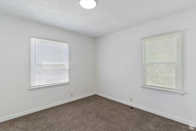 3214 Porter Ave, Ogden, UT 84403 - unfurnished room with dark colored carpet, a textured ceiling, and baseboards