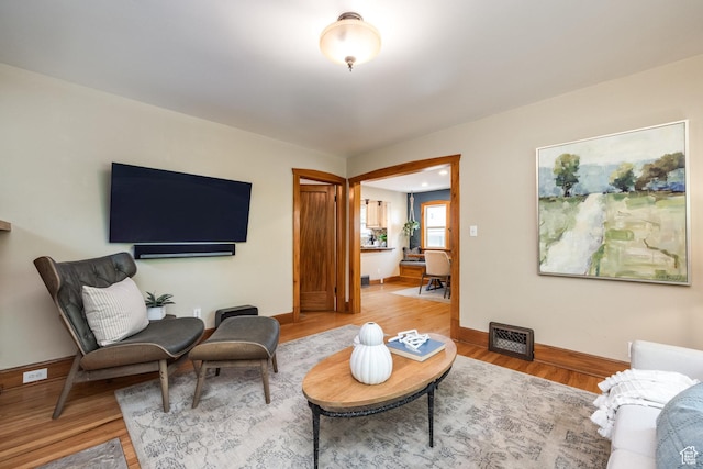 living area with wood finished floors and baseboards