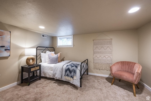 bedroom with carpet floors, recessed lighting, baseboards, and a textured ceiling