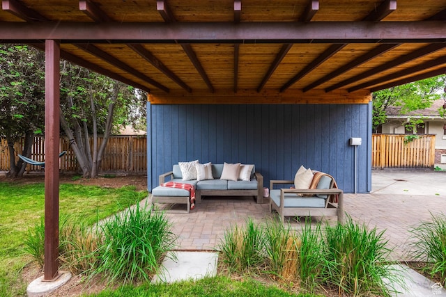 view of patio featuring outdoor lounge area and fence