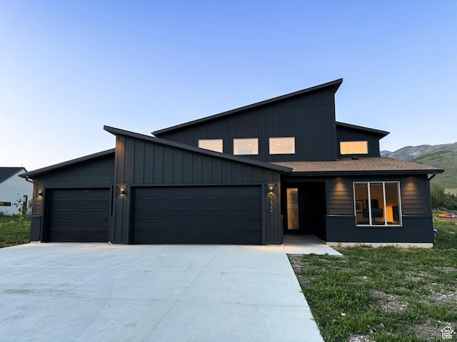 3232 E 5225 N, Eden, UT 84310 - modern home featuring an attached garage, concrete driveway, board and batten siding, and a mountain view