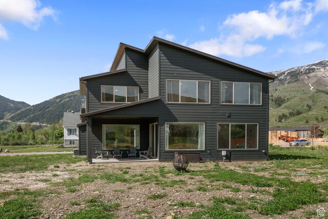 3232 E 5225 N, Eden, UT 84310 - rear view of property with a mountain view, an outdoor fire pit, and a patio area