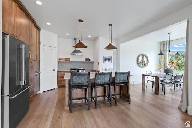 3232 E 5225 N, Eden, UT 84310 - kitchen featuring high quality fridge, open shelves, light wood-style floors, brown cabinetry, and a breakfast bar