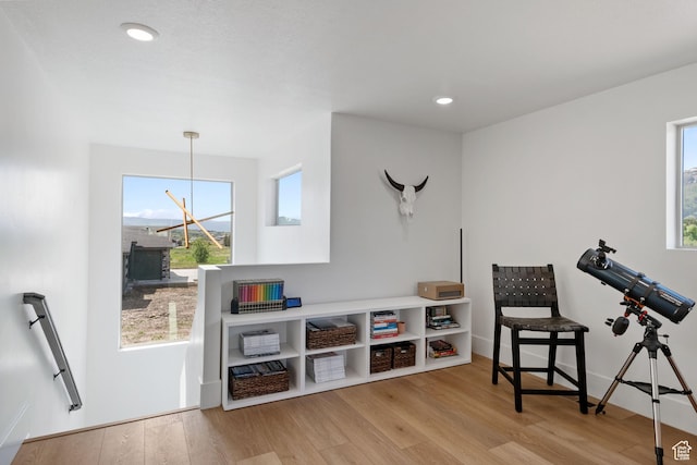 3232 E 5225 N, Eden, UT 84310 - living area featuring wood finished floors, healthy amount of natural light, recessed lighting, a chandelier, and an upstairs landing