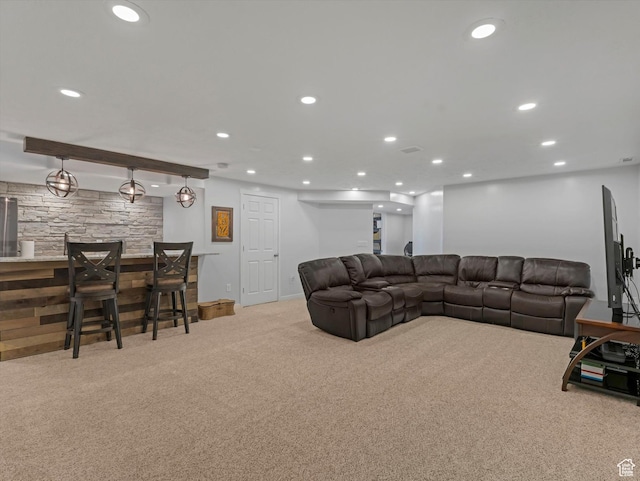 carpeted living area with bar area, recessed lighting, and baseboards