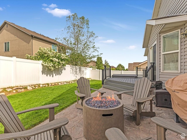 view of patio / terrace featuring a fire pit and a wooden deck