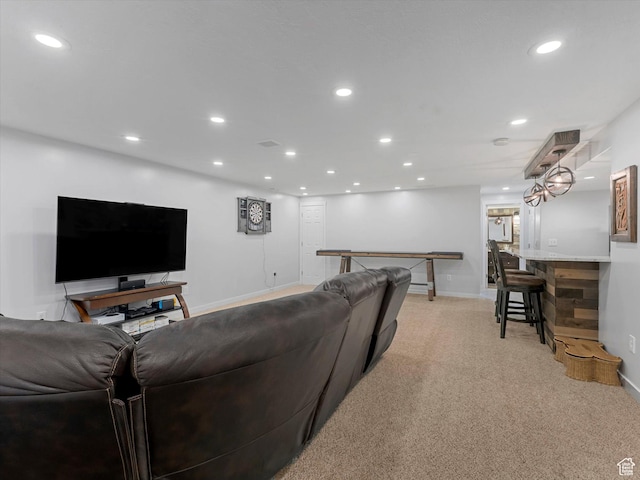 living room with recessed lighting, light carpet, and baseboards