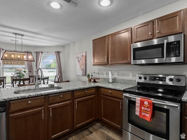 1370 S 1500 W, Springville, UT 84663 - kitchen featuring stainless steel appliances, a sink, dark wood finished floors, light stone counters, and a textured ceiling