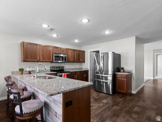 1370 S 1500 W, Springville, UT 84663 - kitchen featuring appliances with stainless steel finishes, a sink, a peninsula, baseboards, and light stone counters