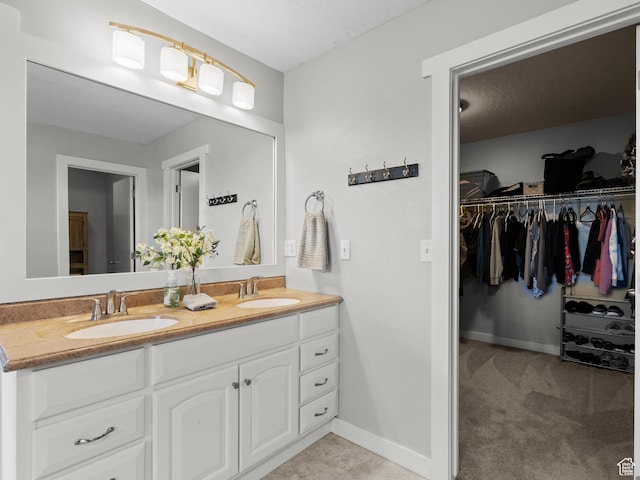 1370 S 1500 W, Springville, UT 84663 - bathroom with double vanity, a walk in closet, and baseboards