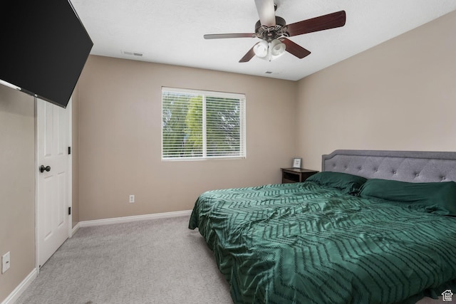 bedroom featuring baseboards, light carpet, and a ceiling fan
