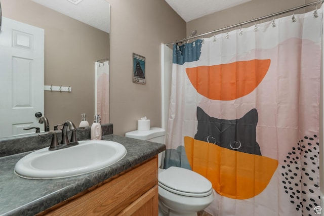 bathroom featuring toilet, vanity, and a shower with curtain