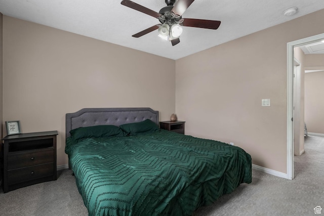 carpeted bedroom featuring baseboards and a ceiling fan