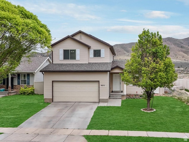 4610 N Long Way, Eagle Mountain, UT 84005 - view of front of property featuring a garage, concrete driveway, a front lawn, and a mountain view