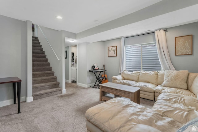carpeted living room featuring stairway and baseboards