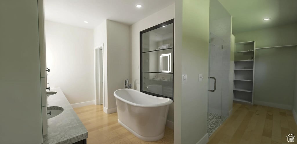 268 W 3400 S Unit 5, Nibley, UT 84321 - bathroom featuring wood finished floors, double vanity, a shower stall, baseboards, and a soaking tub