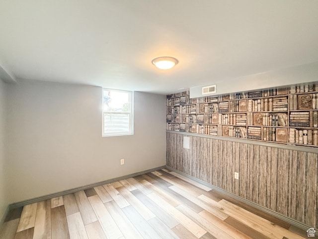 empty room with wood finished floors and baseboards
