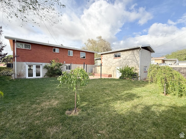 back of house featuring french doors and a yard