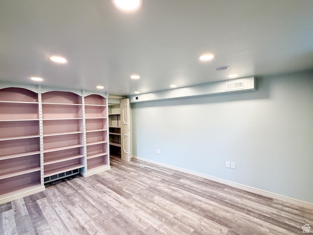 finished basement with wood finished floors, recessed lighting, and baseboards