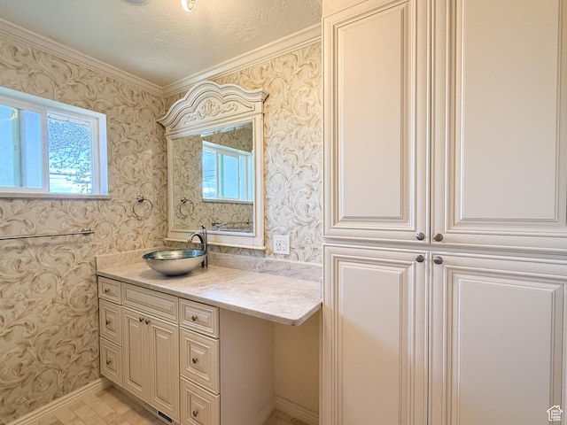 bathroom with wallpapered walls, vanity, crown molding, and baseboards