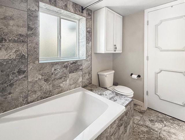 bathroom featuring a bath and toilet