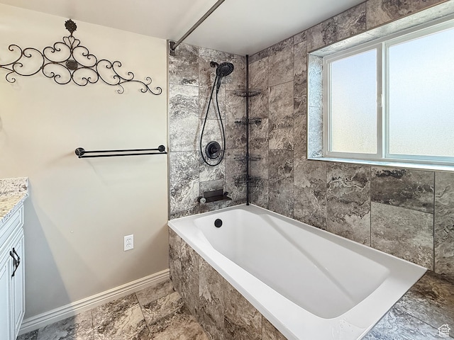 bathroom featuring baseboards, vanity, and shower / bath combination