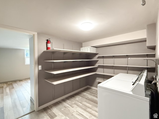 storage area featuring independent washer and dryer