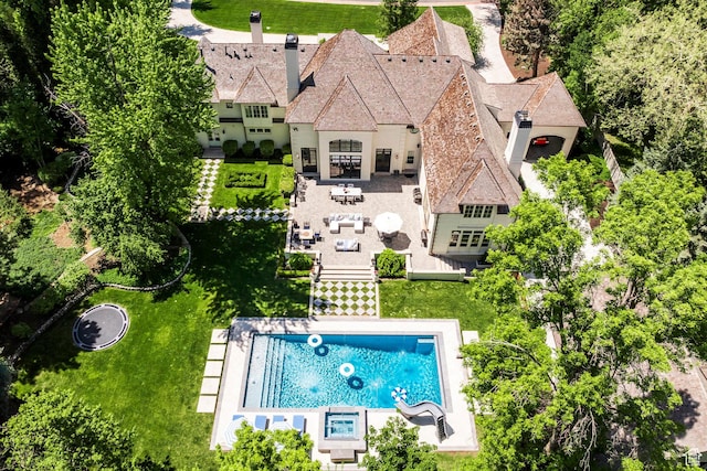 aerial view of property and surrounding area with a pool