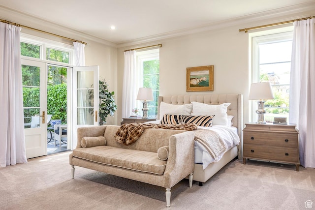 bedroom with ornamental molding, light colored carpet, access to outside, and multiple windows