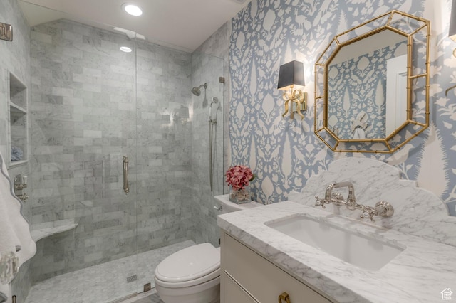 bathroom with toilet, a stall shower, wallpapered walls, recessed lighting, and vanity
