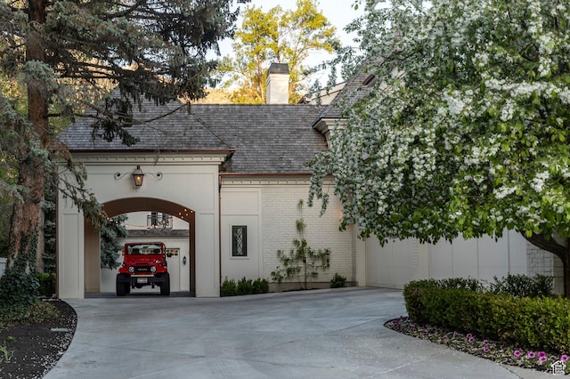 view of property featuring driveway and a garage