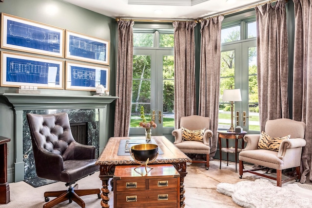 sitting room with french doors, a premium fireplace, and carpet floors