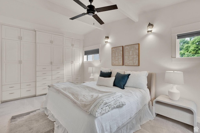 bedroom with multiple windows, light carpet, ceiling fan, and a closet