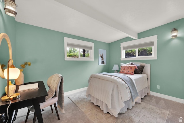 bedroom featuring multiple windows, beam ceiling, light carpet, baseboards, and an office area