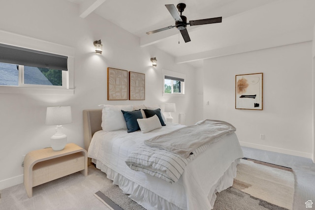 bedroom featuring baseboards, light colored carpet, and ceiling fan