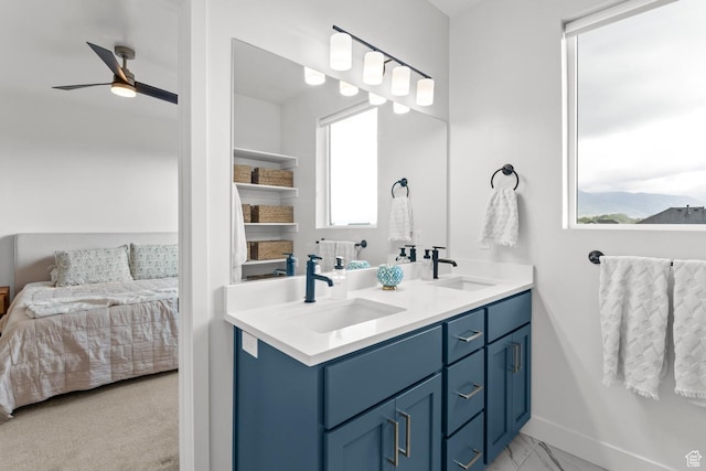 422 S 700 W, American Fork, UT 84003 - ensuite bathroom featuring a ceiling fan, double vanity, marble finish flooring, and baseboards