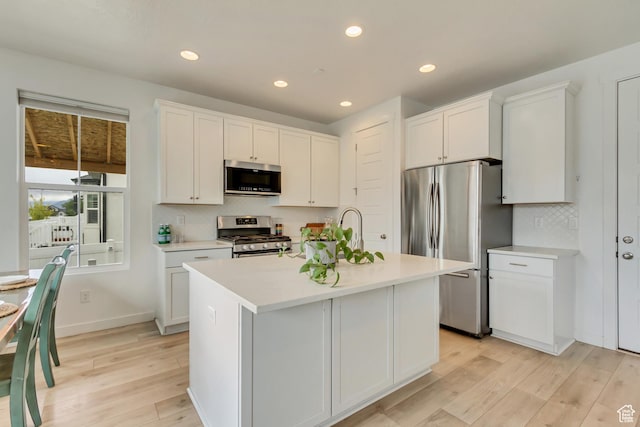 1343 N 3350 W, Provo, UT 84601 - kitchen with stainless steel appliances, light wood finished floors, light countertops, backsplash, and white cabinetry
