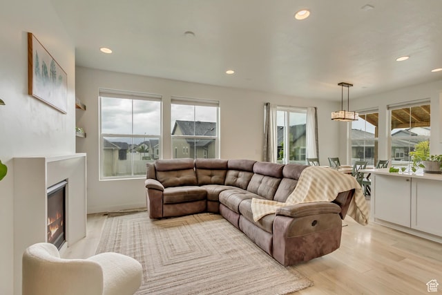 1343 N 3350 W, Provo, UT 84601 - living room featuring light wood-style floors, a glass covered fireplace, and recessed lighting